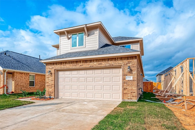 traditional-style house with brick siding, fence, driveway, and a front yard
