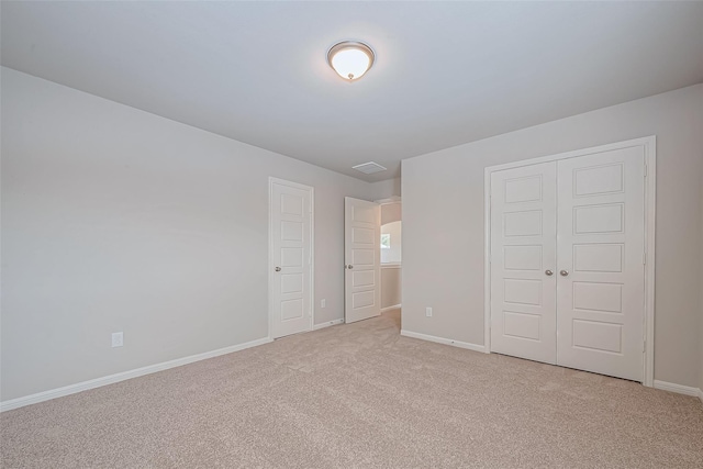 unfurnished bedroom featuring carpet floors, baseboards, and a closet