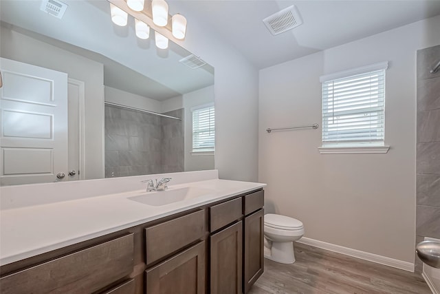 full bath featuring visible vents, plenty of natural light, and tiled shower