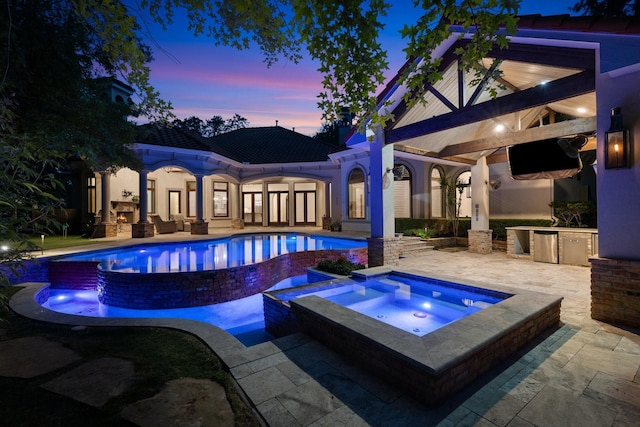 outdoor pool featuring area for grilling, a patio, and an in ground hot tub