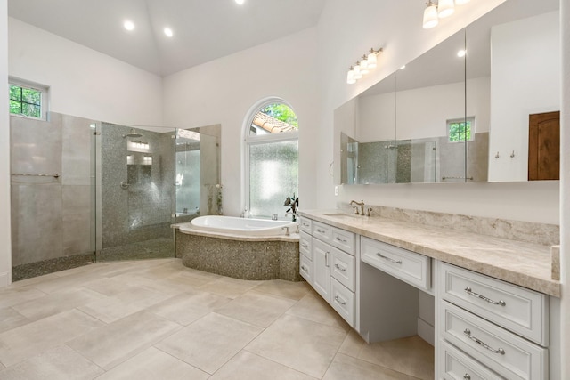 bathroom with a bath, a tile shower, vanity, tile patterned floors, and recessed lighting