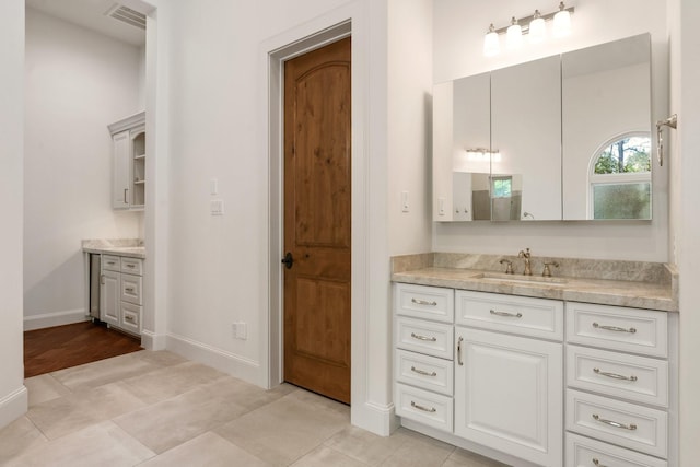full bath featuring baseboards, visible vents, and vanity