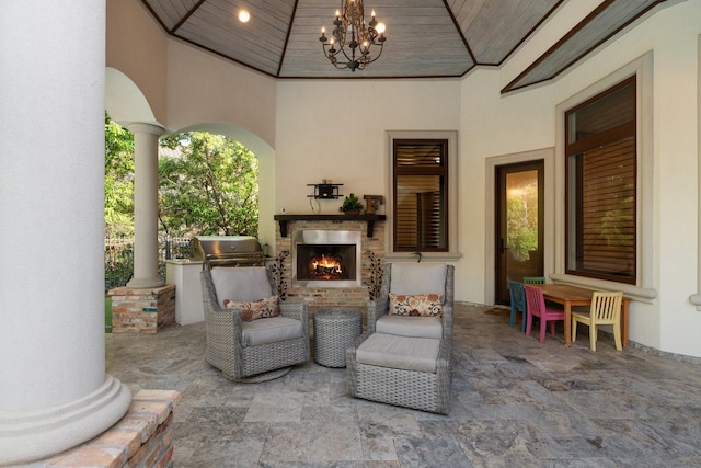 view of patio / terrace featuring a grill and an outdoor brick fireplace
