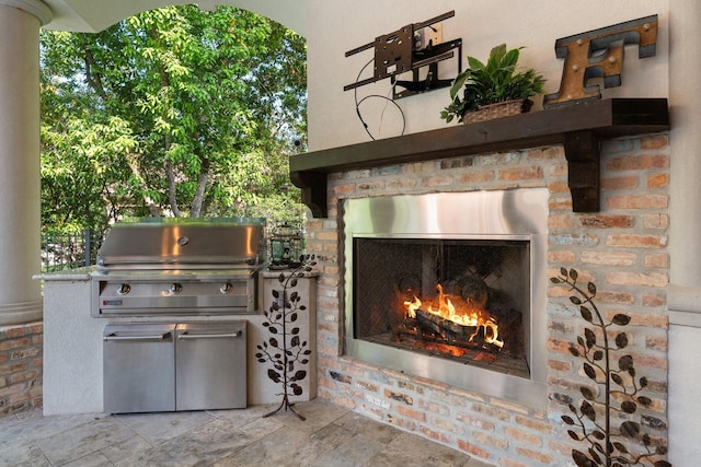 exterior details featuring stucco siding, a lit fireplace, and stone siding