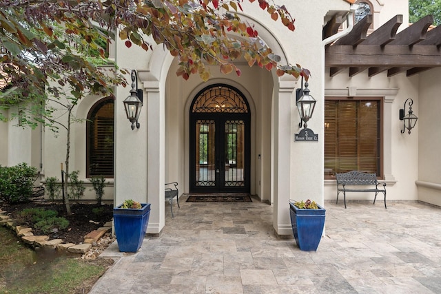 doorway to property with french doors and stucco siding