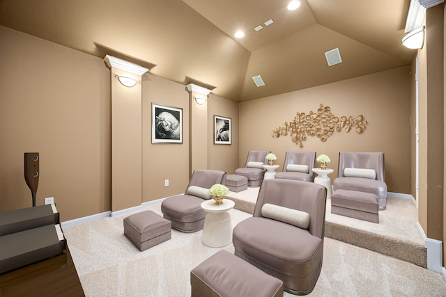 carpeted home theater featuring baseboards, ornate columns, lofted ceiling, and wood finished floors