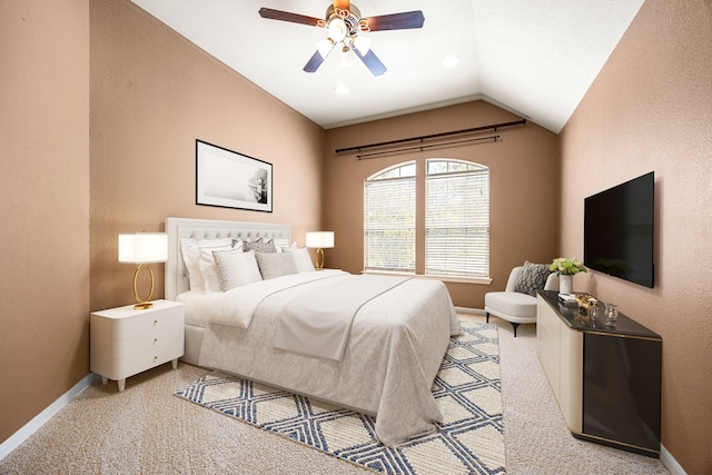 bedroom with a ceiling fan, a textured wall, lofted ceiling, baseboards, and carpet flooring