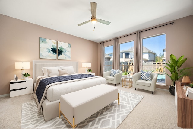 bedroom featuring baseboards, a ceiling fan, light carpet, and access to exterior