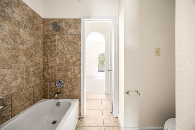bathroom with toilet, shower / bath combination, baseboards, and tile patterned flooring