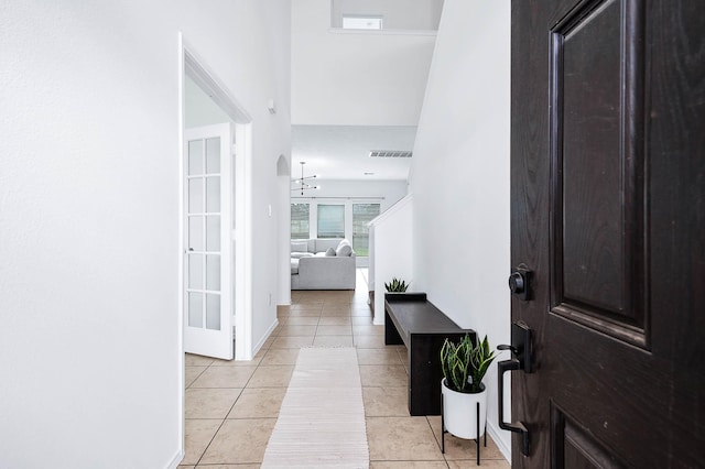 entrance foyer with light tile patterned floors and visible vents