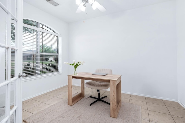 tiled office space featuring baseboards, a ceiling fan, and visible vents