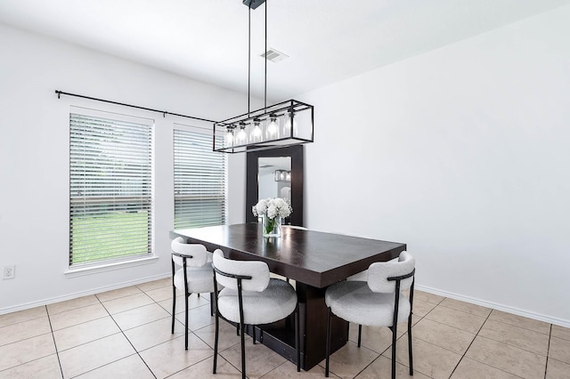 dining area with light tile patterned floors, visible vents, and baseboards