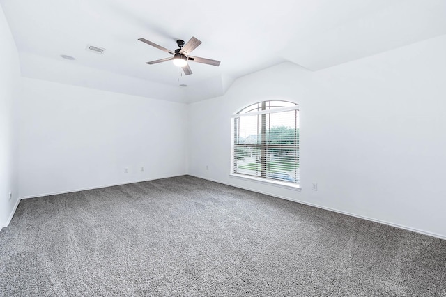 carpeted empty room featuring baseboards, ceiling fan, lofted ceiling, and visible vents