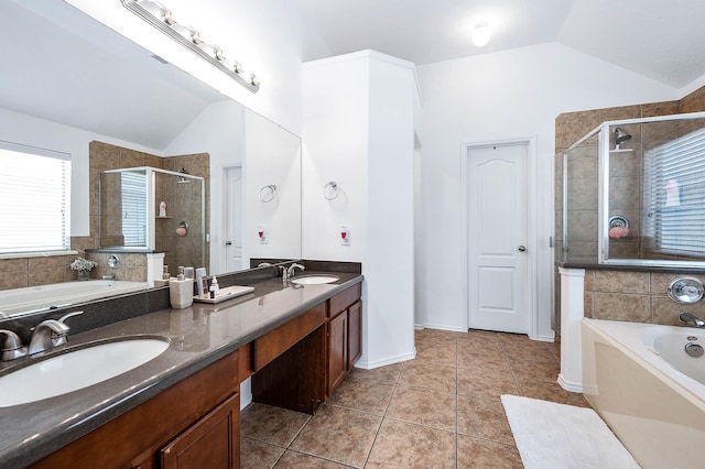 bathroom featuring a bath, a stall shower, lofted ceiling, and a sink