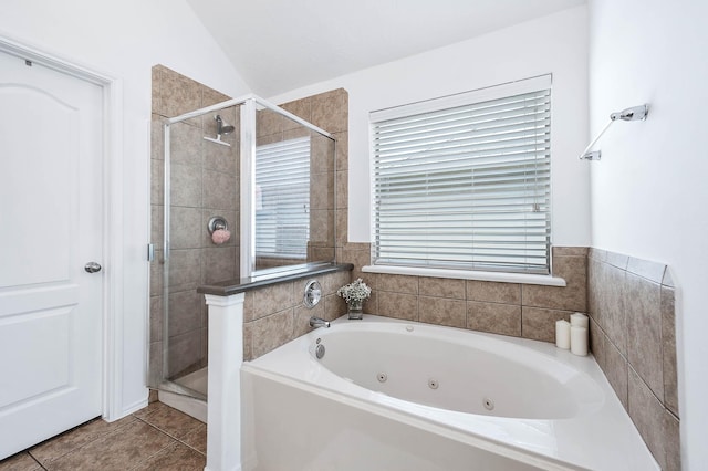 bathroom featuring a tub with jets, tile patterned flooring, a shower stall, and vaulted ceiling