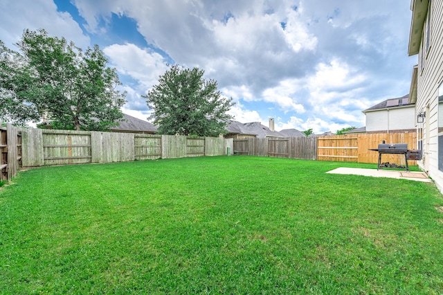 view of yard featuring a patio area and a fenced backyard