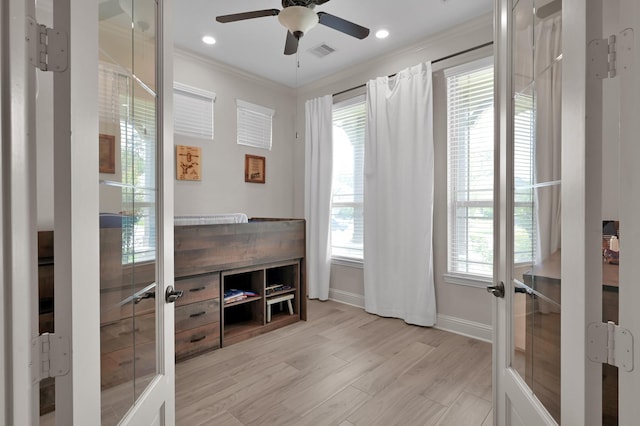 office area with crown molding, a ceiling fan, baseboards, and light wood-type flooring