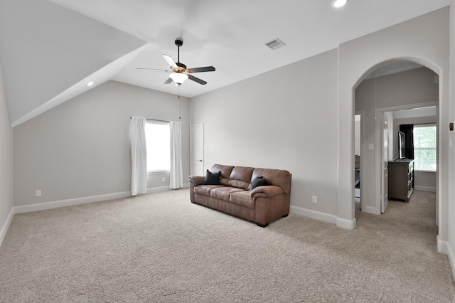 living area with arched walkways, a ceiling fan, carpet flooring, lofted ceiling, and recessed lighting