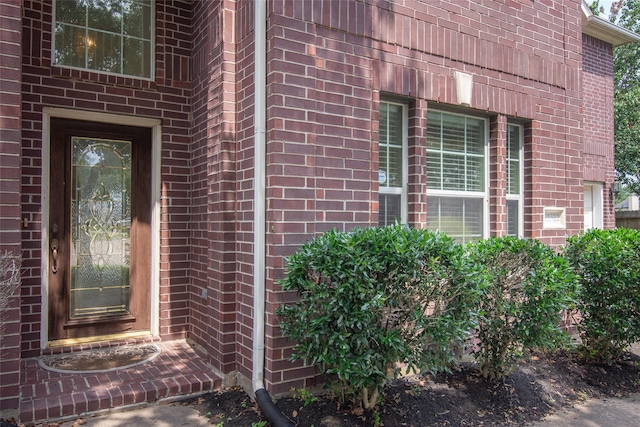 property entrance with brick siding