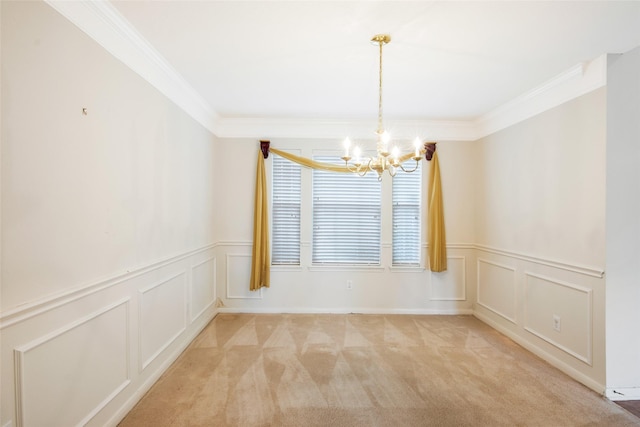 unfurnished room featuring ornamental molding, a decorative wall, light colored carpet, a wainscoted wall, and a chandelier