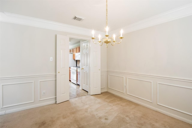 unfurnished dining area featuring a decorative wall, ornamental molding, a notable chandelier, and visible vents