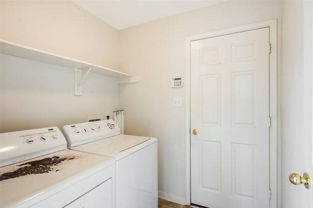 washroom with laundry area, baseboards, and separate washer and dryer