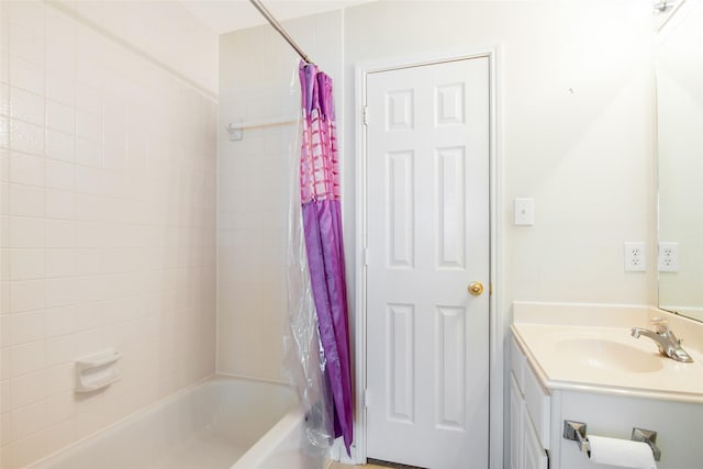bathroom featuring shower / tub combo and vanity