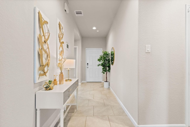corridor with visible vents, recessed lighting, baseboards, and light tile patterned floors