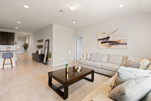 living room featuring recessed lighting, light tile patterned flooring, and visible vents