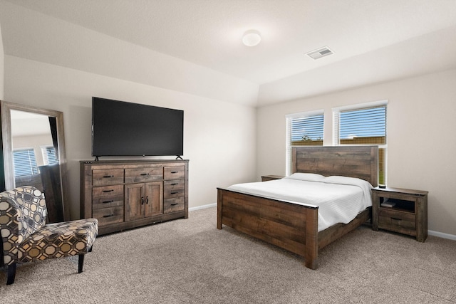 bedroom featuring visible vents, light carpet, and multiple windows