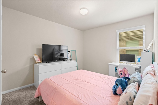 carpeted bedroom featuring baseboards