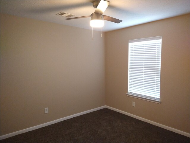 811 Sweet Flower Dr, Houston, TX 77073 - spare room featuring a ceiling fan, plenty of natural light, dark carpet, and baseboards