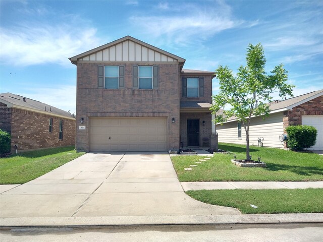 811 Sweet Flower Dr, Houston, TX 77073 - view of front of house featuring brick siding, board and batten siding, a front lawn, concrete driveway, and a garage