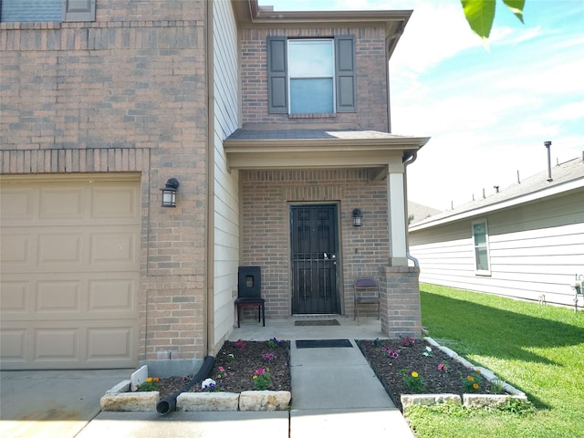 811 Sweet Flower Dr, Houston, TX 77073 - view of exterior entry with brick siding, a garage, and a yard