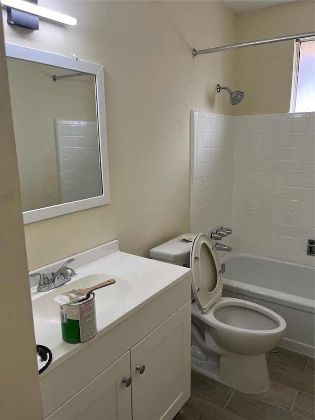 bathroom featuring shower / tub combination, toilet, vanity, and wood finished floors