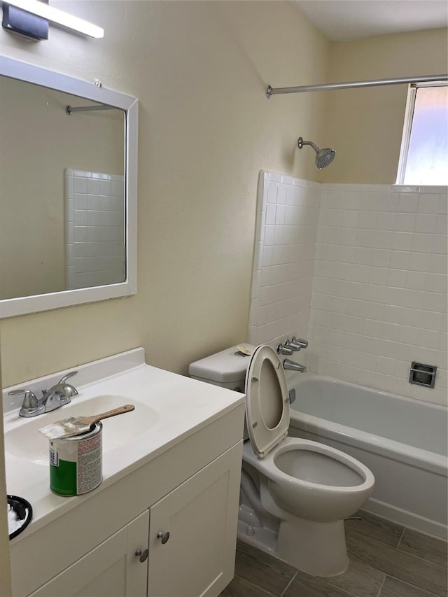bathroom with toilet, washtub / shower combination, and vanity