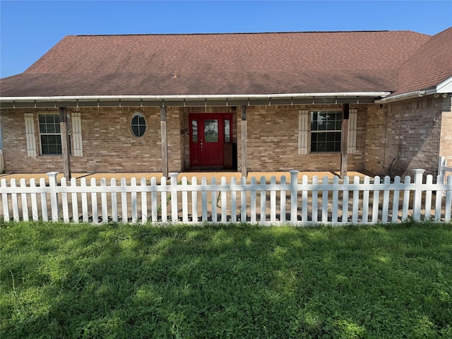 13796 County Road 318, Navasota, TX 77868 - ranch-style house with brick siding, a fenced front yard, and a shingled roof