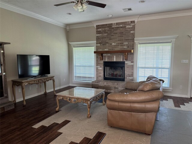 13796 County Road 318, Navasota, TX 77868 - living room with ceiling fan, healthy amount of natural light, ornamental molding, baseboards, and a brick fireplace