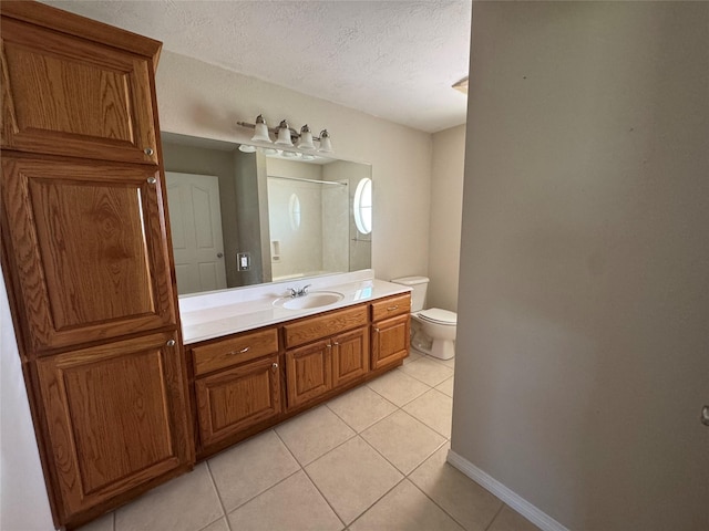 13796 County Road 318, Navasota, TX 77868 - bathroom with tile patterned flooring, toilet, a textured ceiling, baseboards, and vanity