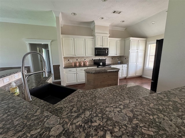 13796 County Road 318, Navasota, TX 77868 - kitchen featuring black appliances, a sink, a center island, decorative backsplash, and crown molding