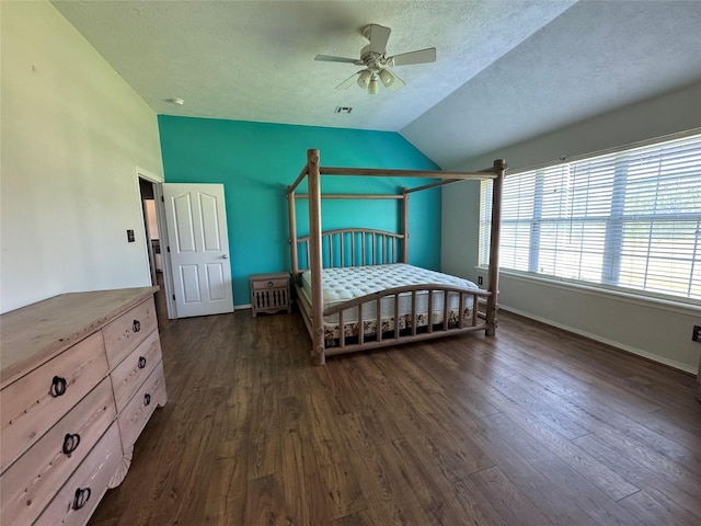 13796 County Road 318, Navasota, TX 77868 - bedroom with lofted ceiling, dark wood finished floors, a textured ceiling, baseboards, and ceiling fan