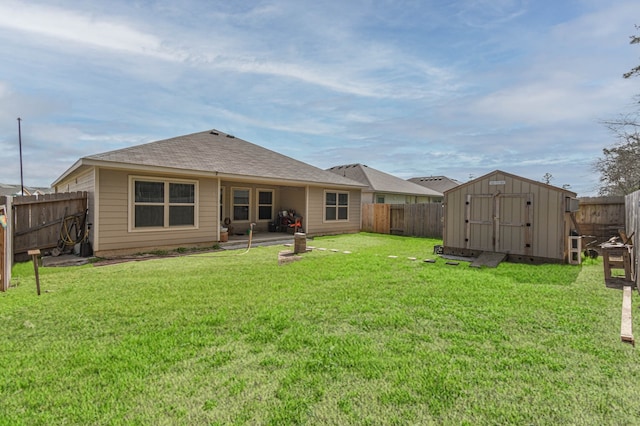9971 Spring Creek Rd, Cleveland, TX 77327 - back of house with a storage unit, a fenced backyard, a lawn, and an outdoor structure