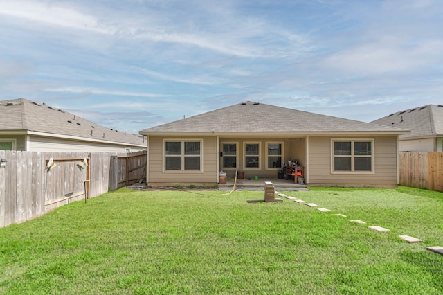 9971 Spring Creek Rd, Cleveland, TX 77327 - back of property featuring a lawn, a fenced backyard, a shingled roof, and a patio
