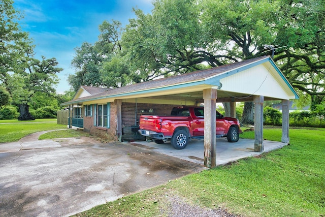 402 E Smith St, Brazoria, TX 77422 - view of home's exterior with a carport, concrete driveway, a yard, and brick siding