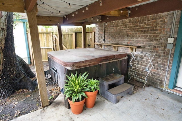 402 E Smith St, Brazoria, TX 77422 - view of patio featuring a hot tub and fence
