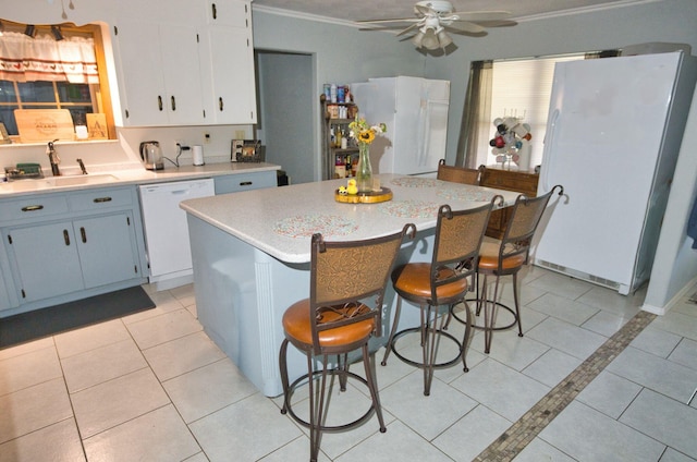402 E Smith St, Brazoria, TX 77422 - kitchen with white appliances, a sink, a ceiling fan, light countertops, and light tile patterned floors