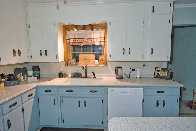 402 E Smith St, Brazoria, TX 77422 - kitchen with white dishwasher, a sink, light countertops, blue cabinetry, and white cabinetry