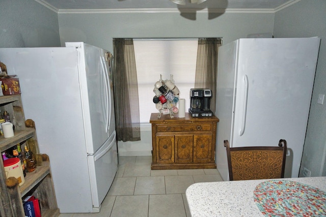 402 E Smith St, Brazoria, TX 77422 - kitchen with freestanding refrigerator, crown molding, ceiling fan, and light tile patterned floors