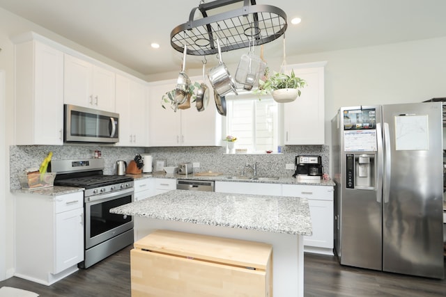 12626 Baker Bend St, Houston, TX 77034 - kitchen featuring a sink, stainless steel appliances, white cabinetry, decorative backsplash, and dark wood-style floors