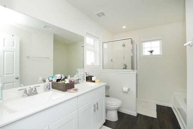 12626 Baker Bend St, Houston, TX 77034 - bathroom featuring visible vents, a shower stall, wood finished floors, a sink, and toilet